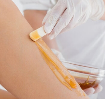 therapist-waxing-womans-leg-spa-center-1